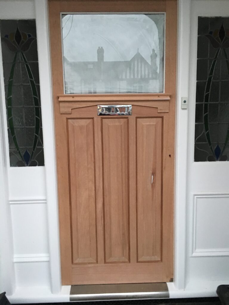 recently manufactured and installed 1930s-style front door