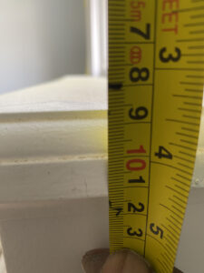 Hand measuring window frame